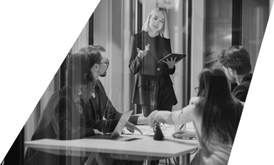A woman is standing in front of a table with a laptop on it.

Description generated by AI